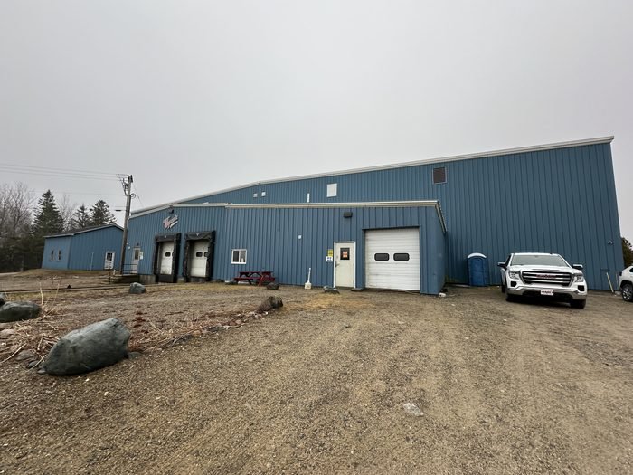 Wide interior view of a pre-engineered metal building with rigid frames and purlins
