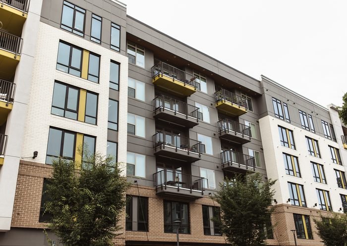 Completed mixed-use multi-family building with masonry and metal panel facade