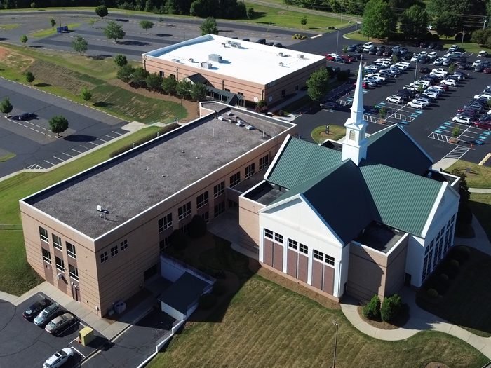 Aerial view of a church campus with a sanctuary and adjoining building