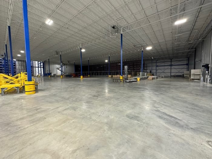 Interior of a distribution facility with a finished slab and racking uprights in place