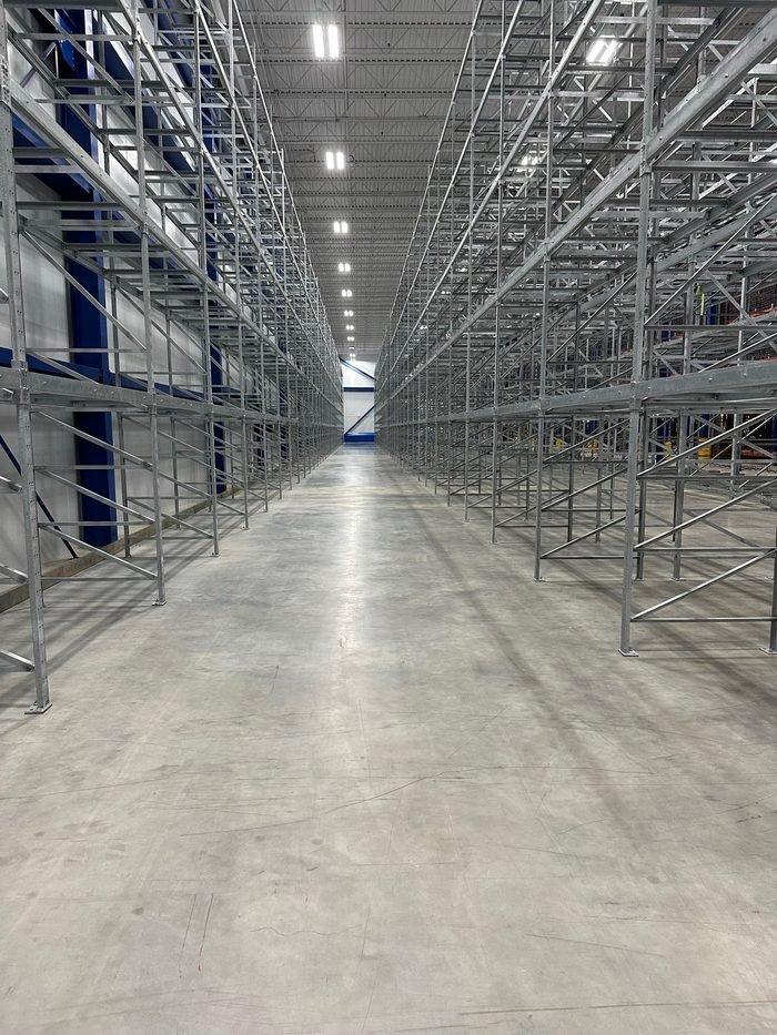 Finished warehouse aisle with racking above a polished industrial slab